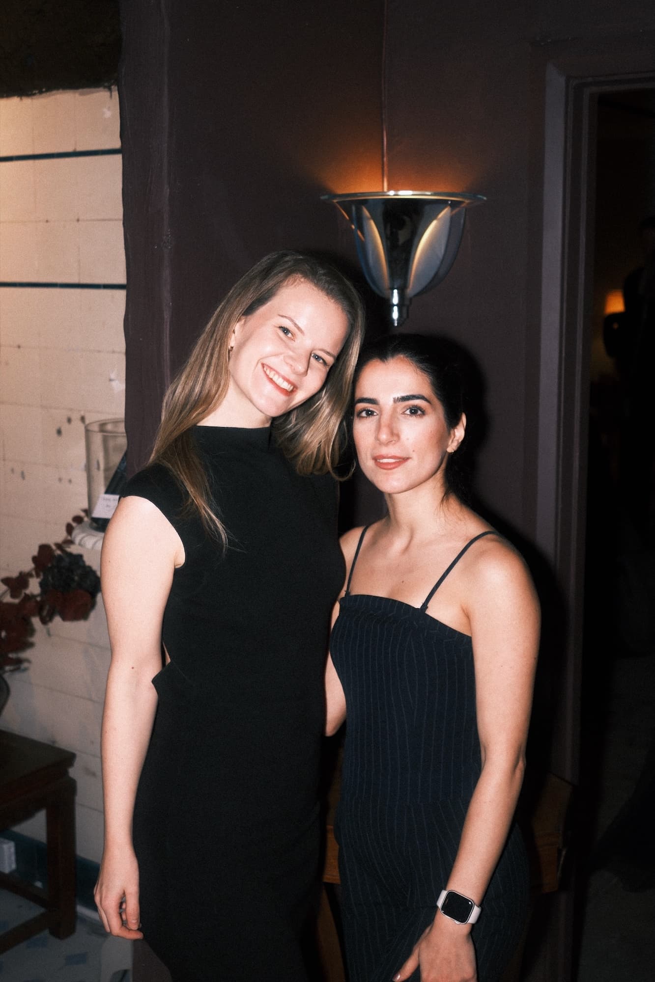 Two guests in black dresses at the club’s gala evening
